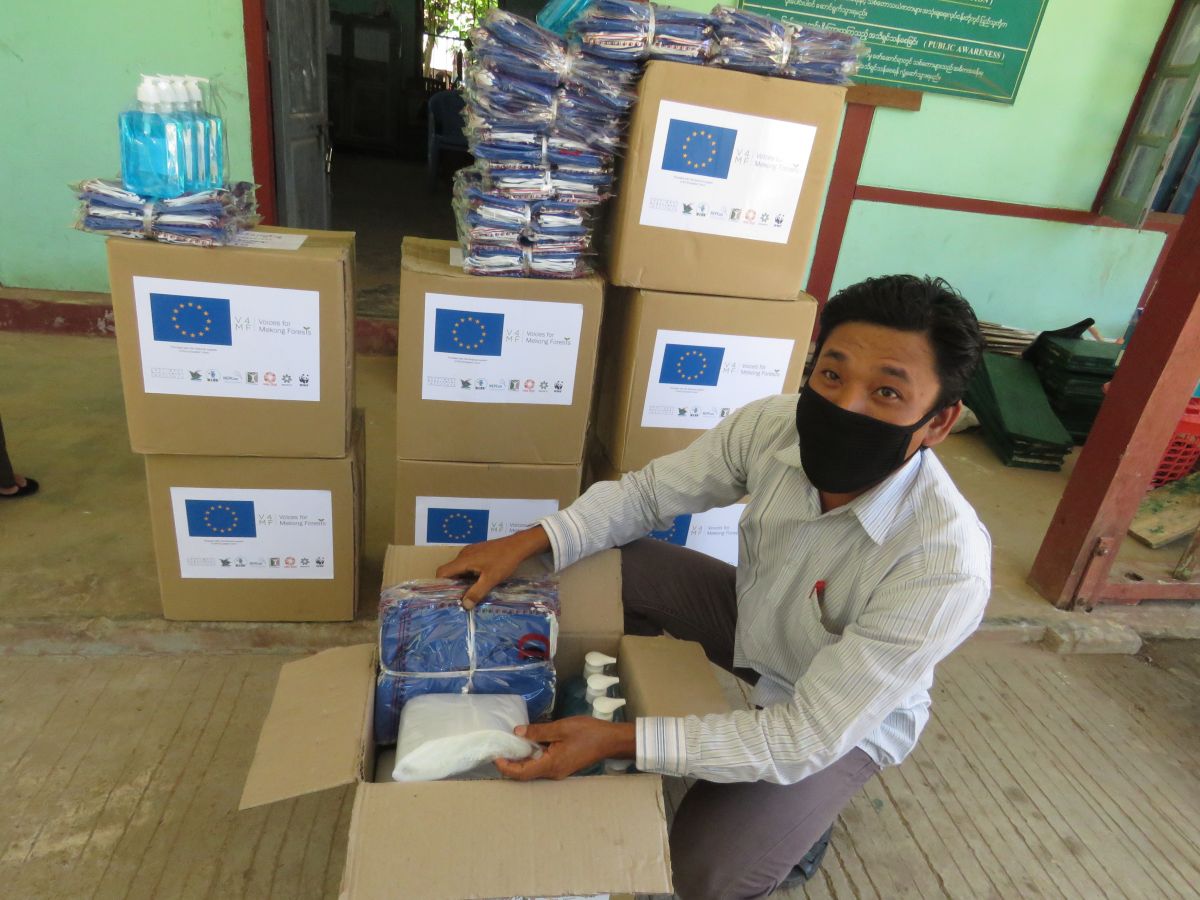 Man unboxes COVID-19 supplies from European Union