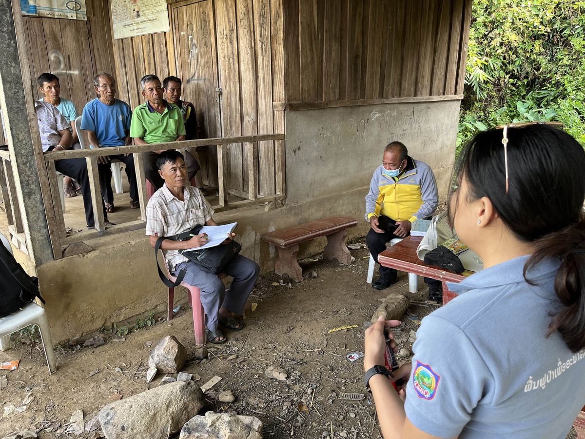 Koulavone Phanthavongsa, project assistant, RECOFTC Lao PDR, discusses income generated from the nursery and handicrafts with community-based enterprise members in Namyonemai village, Bokeo Province, Lao PDR.  Photo: RECOFTC