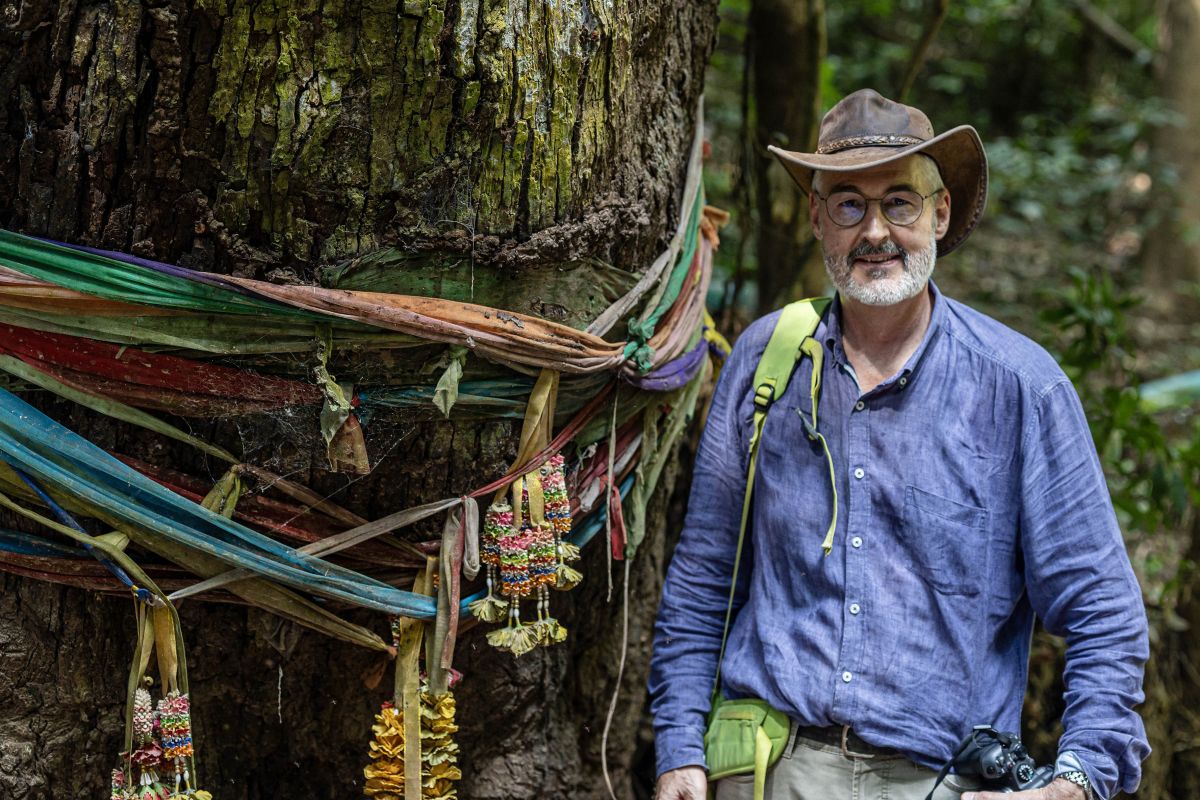 HE Mr Zwahlen next to an ordained tree at Ban Kung Heng Watershed Conservation Area.