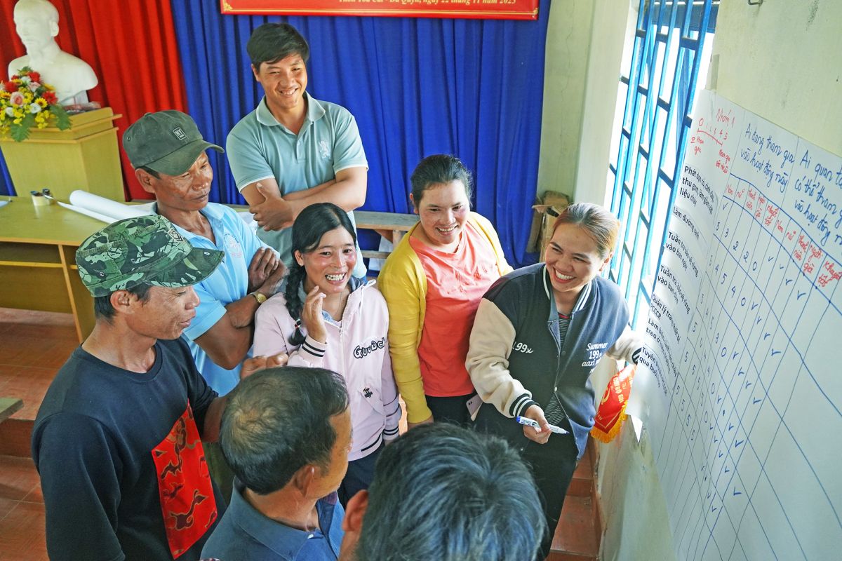 Women in Tan Ha village are taking leadership roles in their team. The group pictured here is discussing the participation of women and men in forest fire management.