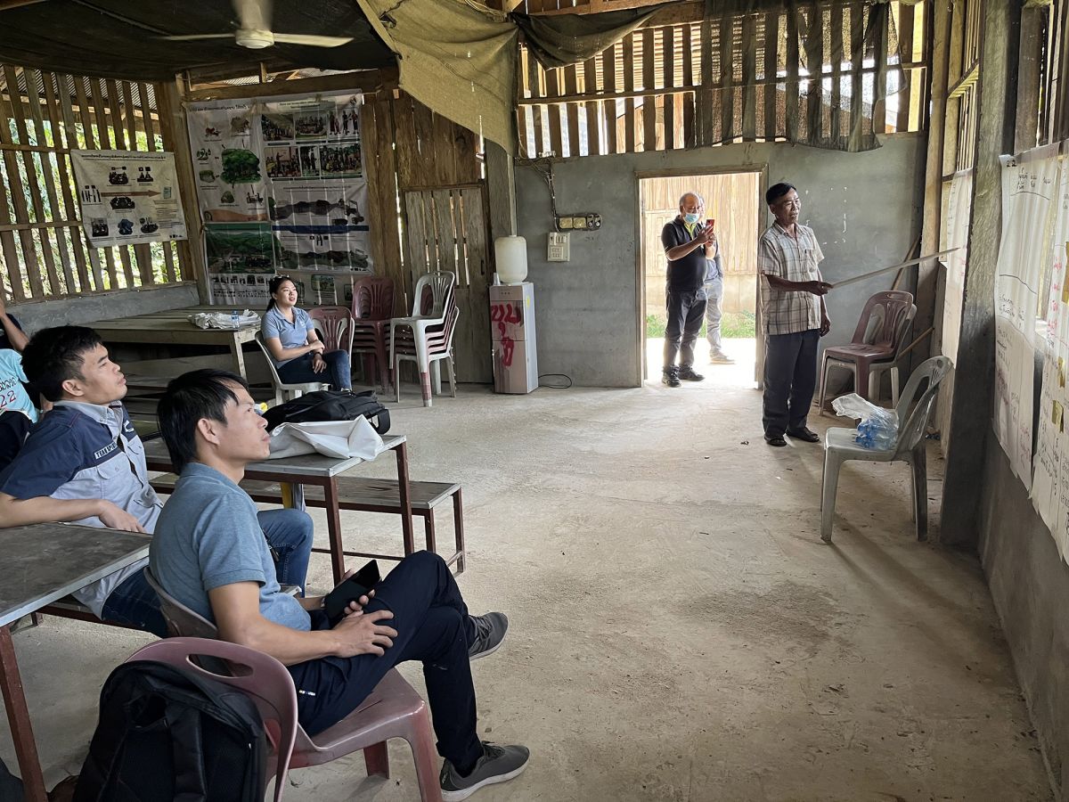 Mr. Inkhong Pilavanh, the village chief, presents the outcomes from the financial monitoring template exercise at the community center in Namyonemai village, Bokeo Province, Lao PDR. Photo: RECOFTC
