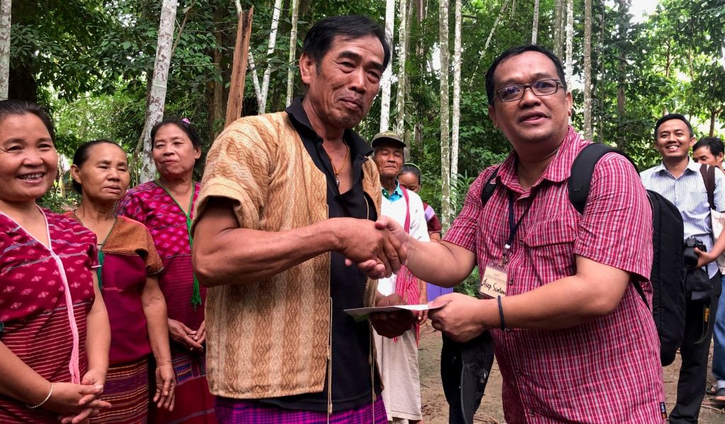 Asep Sugih Suntana receives a souvenir from the Head of Sub-District on behalf of the Indonesian delegation.